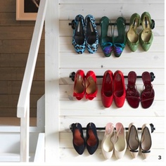 Repurposed curtain rod to a shoe rack.